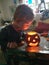 Boy blowing Jack-o-lantern out