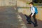 Boy with a blue backpack behind him, after school, climbs the stairs to the top