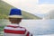boy in a blue hat sails on a ferry across the Bay of Kotor and e