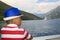 boy in a blue hat sails on a ferryboat across the Bay of Kotor a