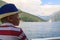 boy in a blue hat sails on a ferryboat across the Bay of Kotor a