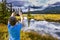 Boy in blue t-shirt photographs landscape