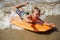 Boy Bodyboarding In Shallow Waves