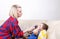 Boy breathe through nebulizer Mother holds a nebulizer mask in the boy`s face during inhalation. Sick chid with