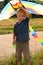 Boy with bright kite in hand