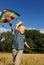 Boy with bright kite over the head