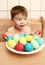 Boy with brightly colored eggs