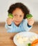 Boy, broccoli and vegetables plate for healthy nutrition meal, diner wellness or food eating. Male person, kid or