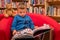 Boy browsing through book in a bookstore