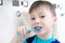 Boy brushing teeth, child dental care, oral hygiene concept, boy portrait in bathroom with tooth brush