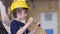 Boy in builder helmet sitting in excavator