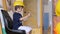 Boy in builder helmet sitting in excavator