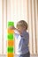 Boy Building Colorful Bricks At Home