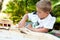 Boy building structure with wooden blocks.