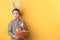 Boy with bunny ears holding a basket with painted eggs