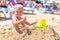 Boy buried in sand on the sea beach