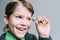 Boy businessman looks through small tube from dollar