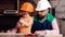 Boy busy in protective helmet learning to twist screws with screwdriver with dad. Workshop and handyman concept. Dad and