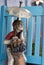 boy caddy figurine sheltering from the rain under umbrella.