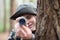 Boy with camera in forest