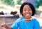 Boy, camping and marshmallow in portrait in nature, sweets and happy for roast candy in woods. African child, summer