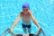 Boy in cap and melting entering in water in pool