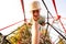 Boy in cap play in rope polyhedron climb at playground outdoor