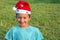 Boy in cap of Santa Claus smiles