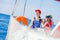 Boy captain with his sister on board of sailing yacht on summer cruise. Travel adventure, yachting with child on family