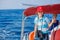 Boy captain with his sister on board of sailing yacht on summer cruise. Travel adventure, yachting with child on family