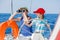 Boy captain with his sister on board of sailing yacht on summer cruise. Travel adventure, yachting with child on family