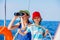 Boy captain with his sister on board of sailing yacht on summer cruise. Travel adventure, yachting with child on family