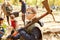 Boy carries an adze ax and helps plant trees