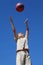 Boy carrom ball upwards and catches him