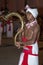 A boy carrying a ceremonial horn parades through the streets of Kandy during the Esala Perahera in Sri Lanka.