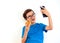 A boy in casual clothes holding donut and cellphone using technologydo selfie