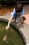 Boy catching little fish with a net