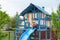 Boy on chair reading while seated on playhouse