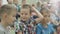 Boy in Checkered Shirt Talks with Friend and Puts Hand up