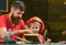 Boy, child busy in protective helmet learning to hammering hobnails with dad. Masculine duties concept. Father, parent