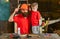 Boy, child cheerful holds toy saw, having fun while handcrafting with dad. Fatherhood concept. Father, parent with beard