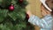 Boy child decorates a Christmas tree