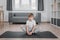 Boy child doing butterfly exercise for mobility of the hip joints on floor on a sports mat