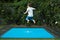 Boy child jumping on trampoline