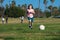 Boy child kicking football on the sports field during soccer match. Child soccer football.