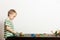 Boy child kid preschooler playing with building blocks toys interior