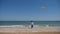 boy child launches a multi-colored kite on the beach in summer