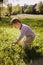 Boy child magnifying glass exploring meadow