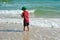 Boy child playing in the sea. Child splashing in the water autdoor. Your holidays at sea. Games in the ocean.