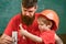 Boy, child in protective helmet makes by hand, repairing, does crafts with dad. Mens work concept. Father with beard and